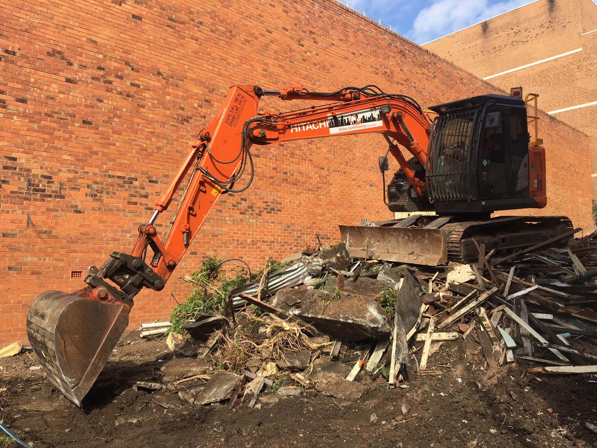 Brisbane CBD Demolition Large orange excavator scooping debris
