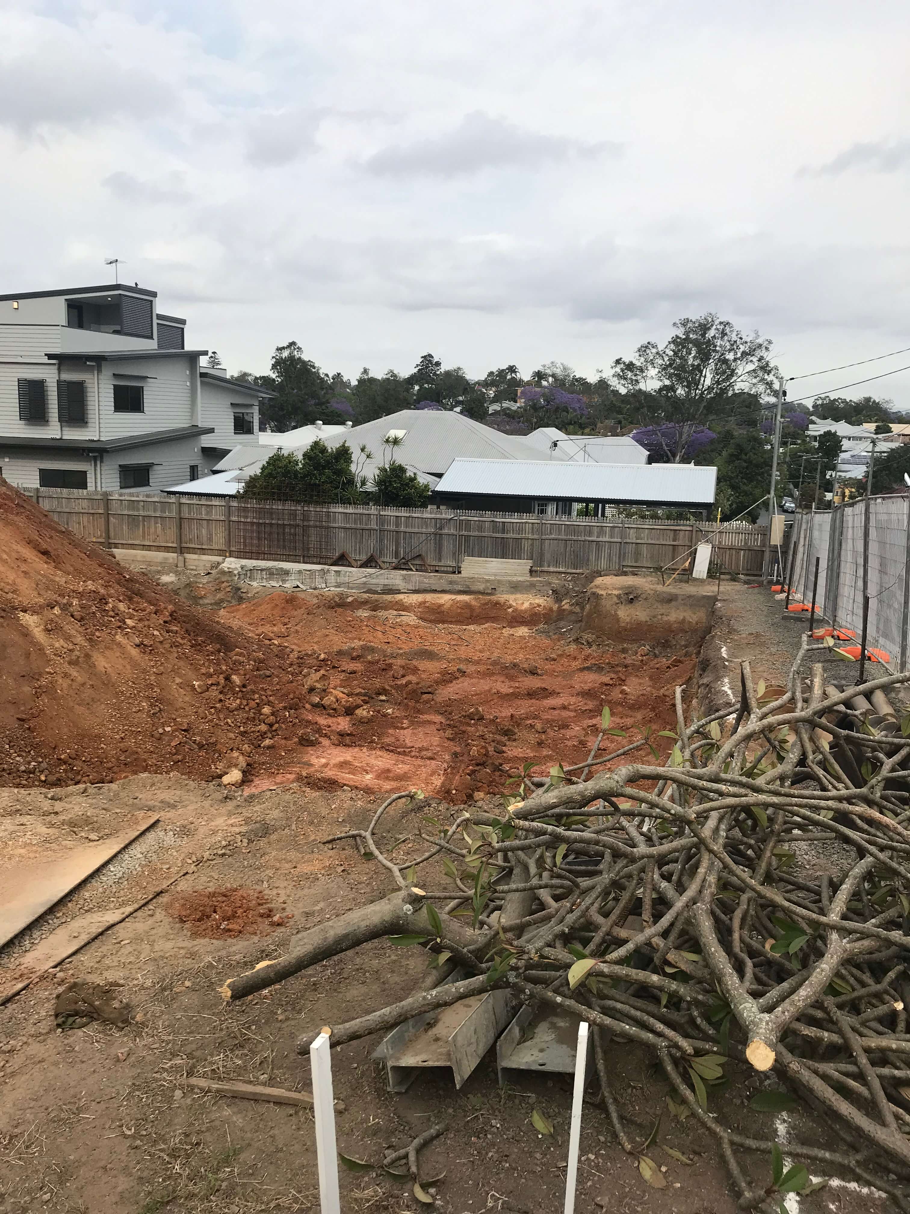 Lutwyche Basement Dig Completed demolition site with tree branch debris