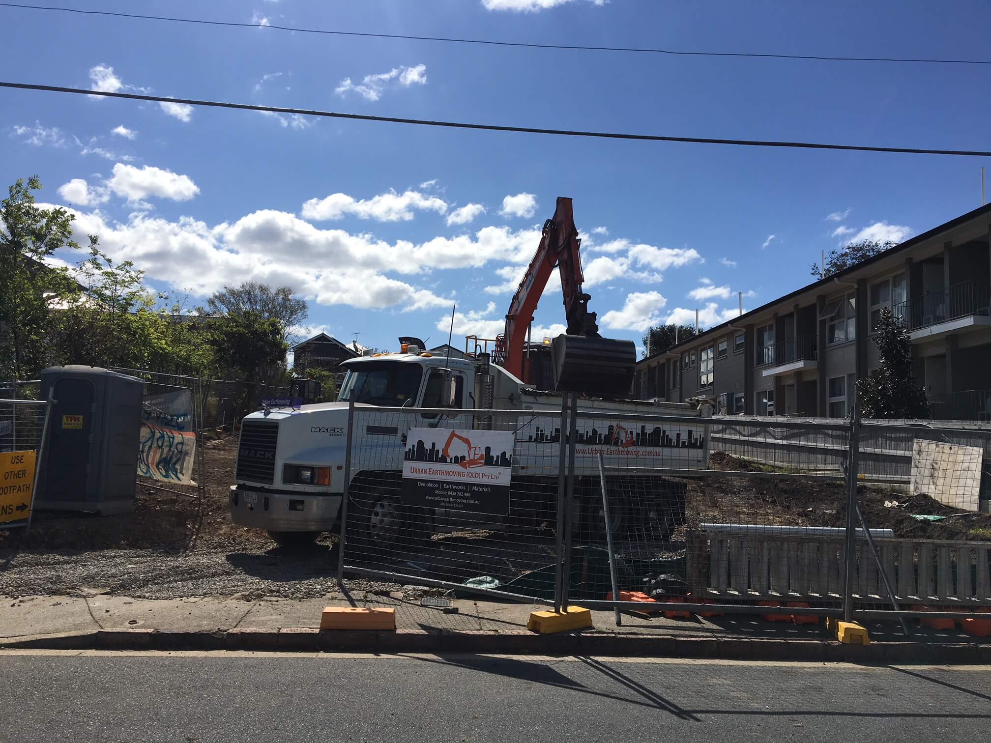 New Farm multi-residential Fenced off demolition site with a truck and excavator in the background
