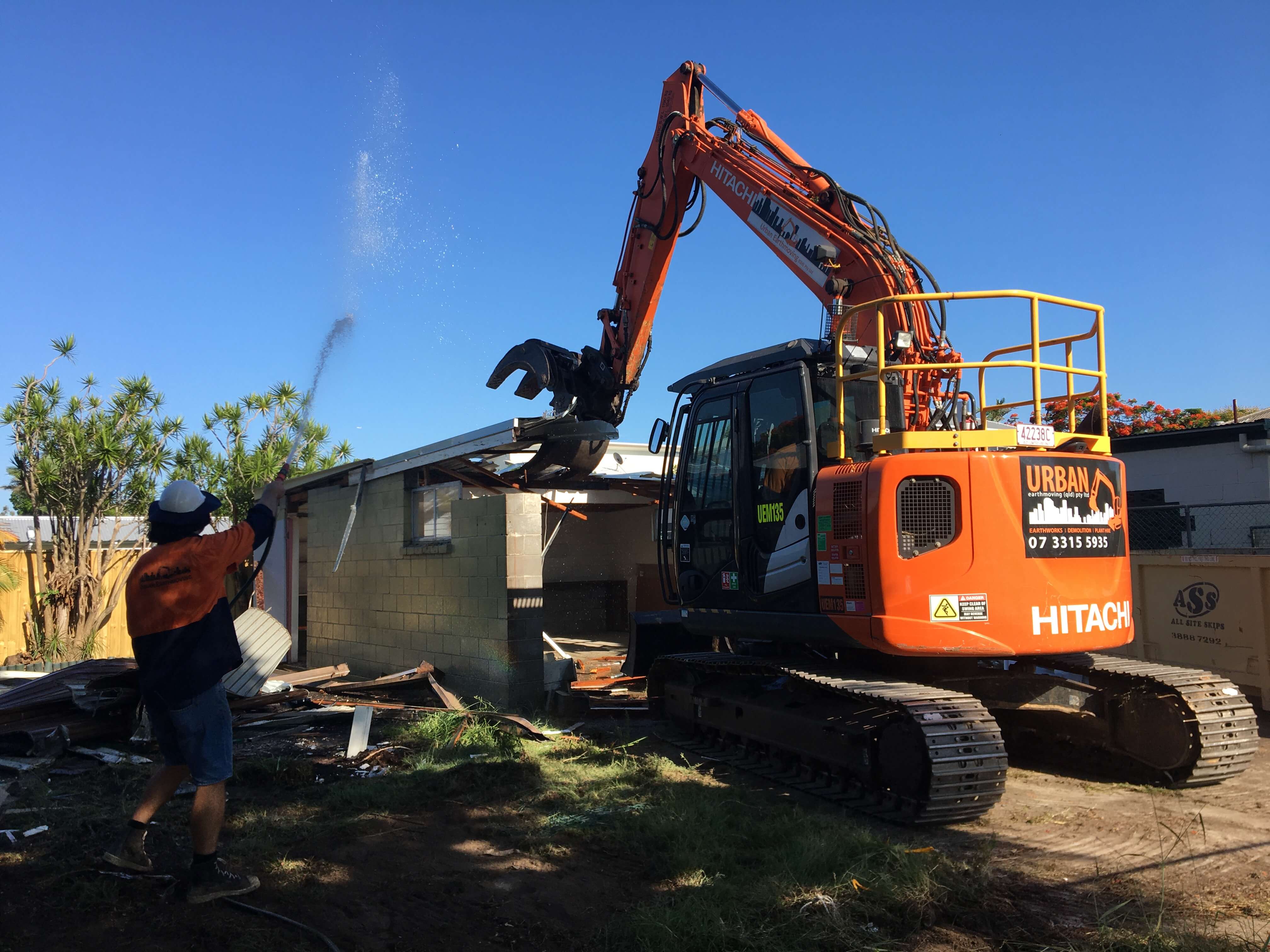 An Urban Demolition excavator demolishing a small granny flat house