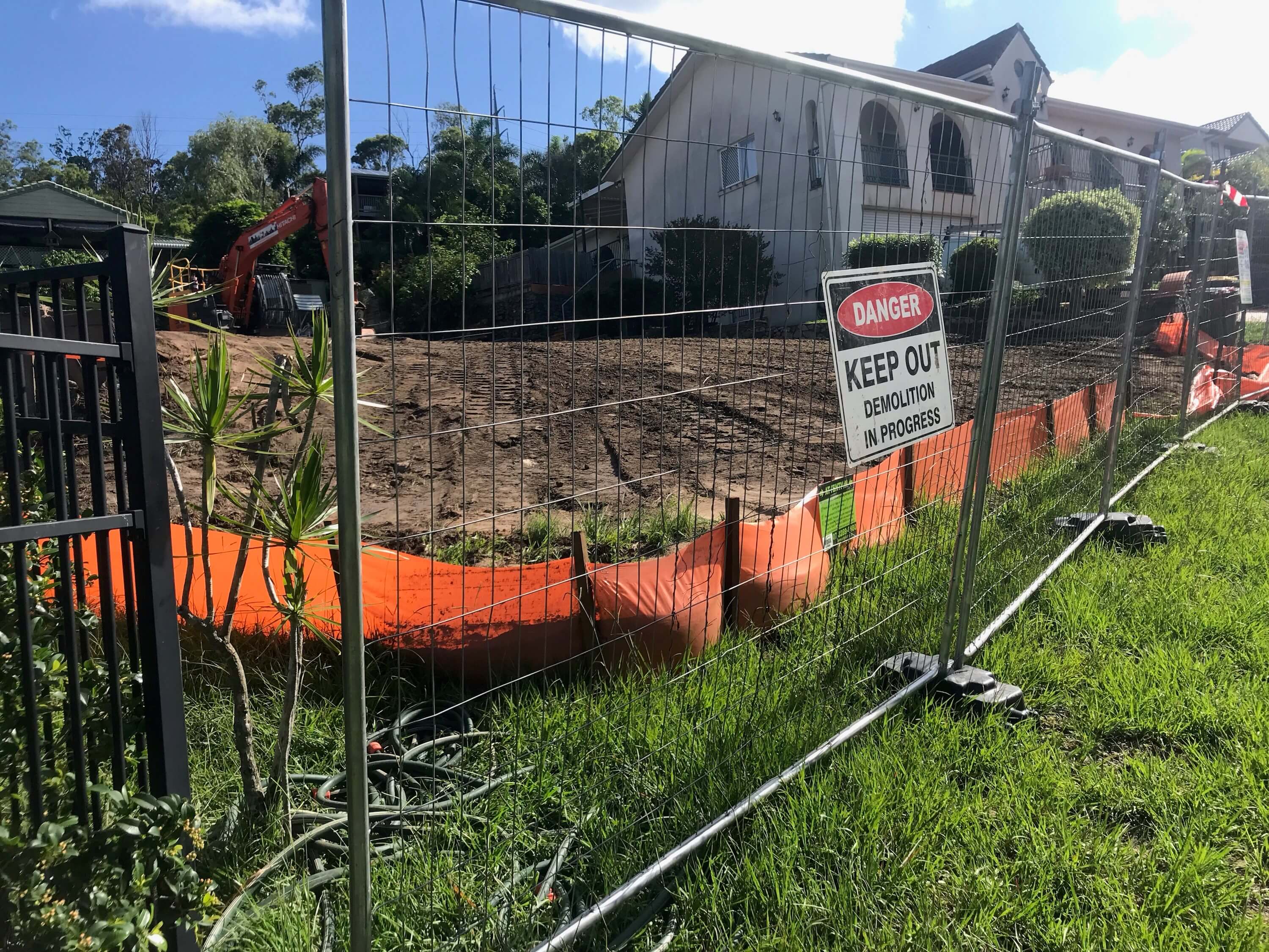 Danger sign on a fenced off demolition area