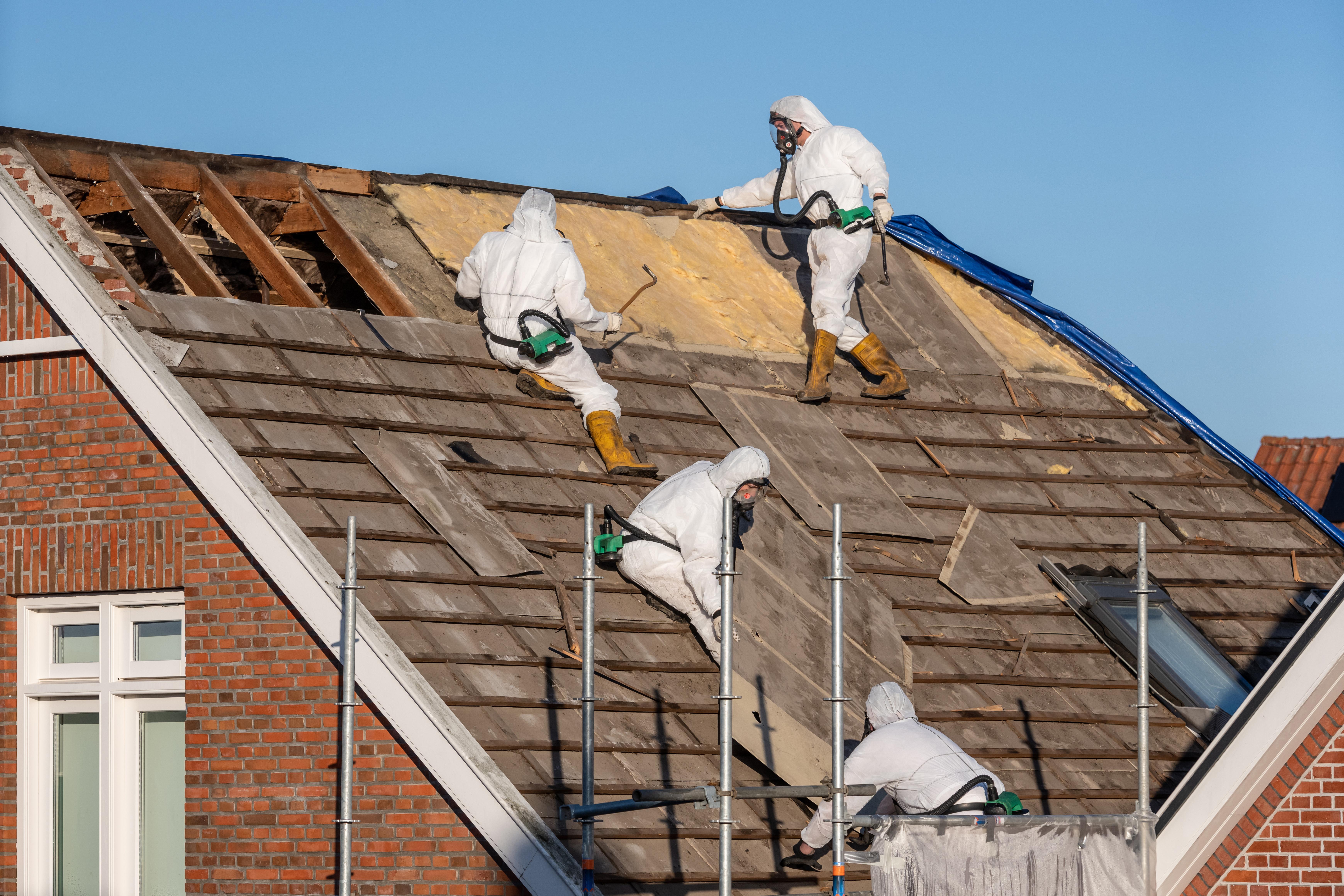 Demolition Services Brisbane Workers removing asbestos off the ceiling of a residential house