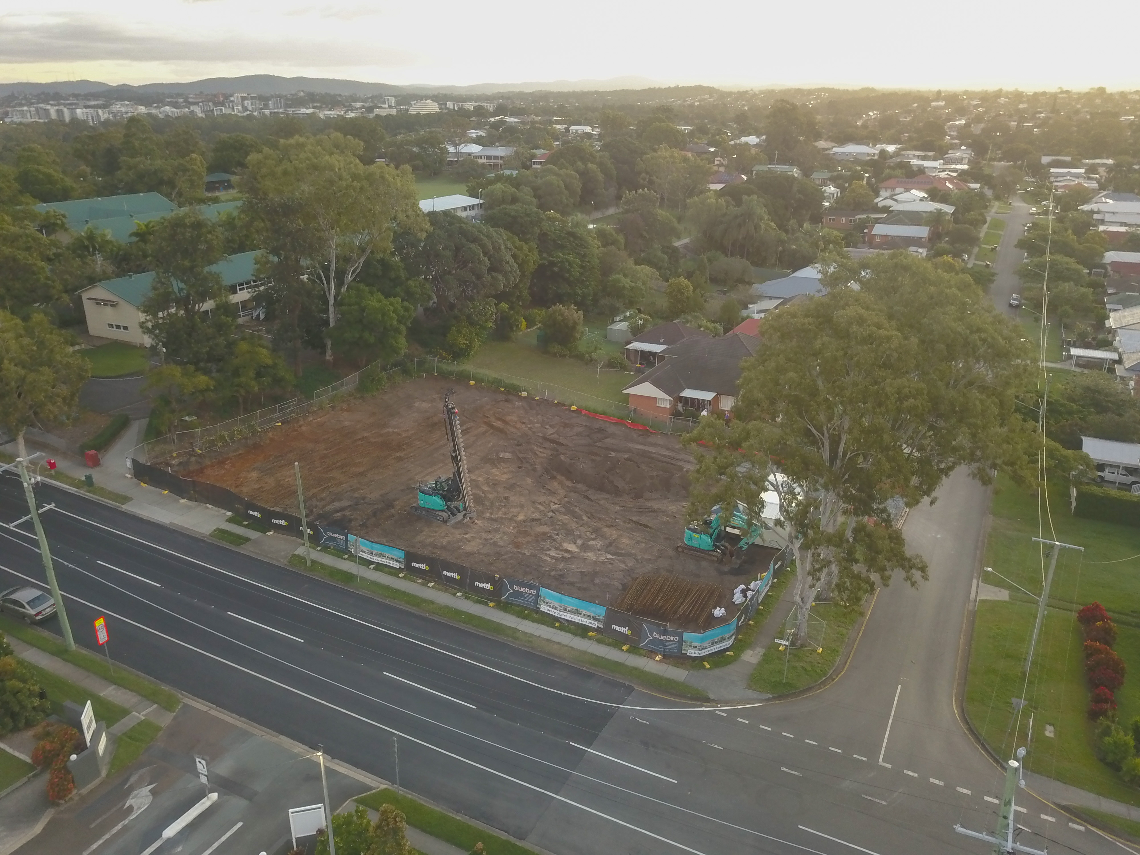 Demolition Services Brisbane Worker in protective gear demolishing a brick wall with a sledge hammer