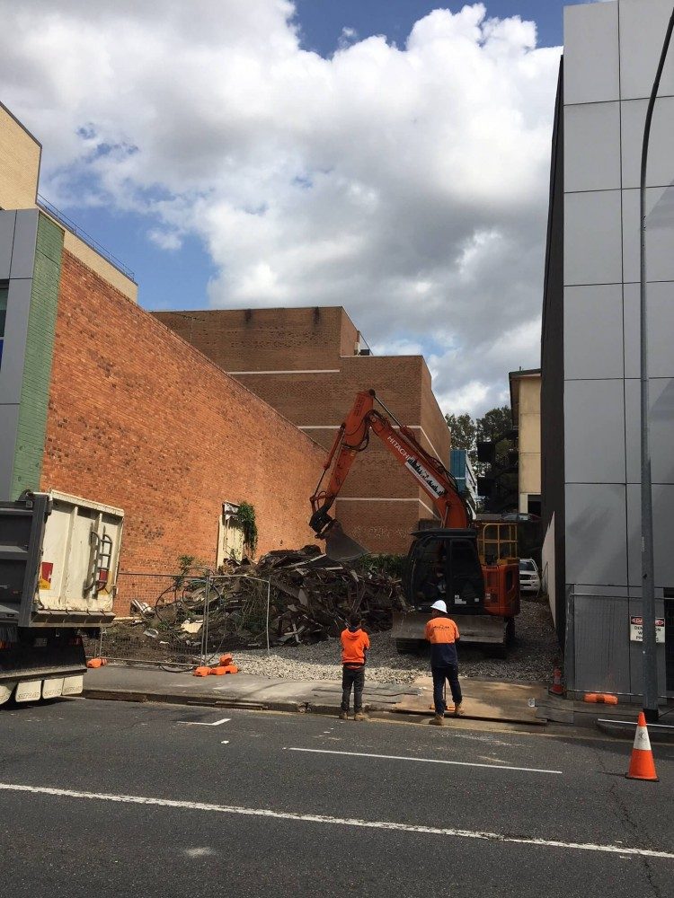 Two Urabn Demolition employees assessing their work after a demolition job